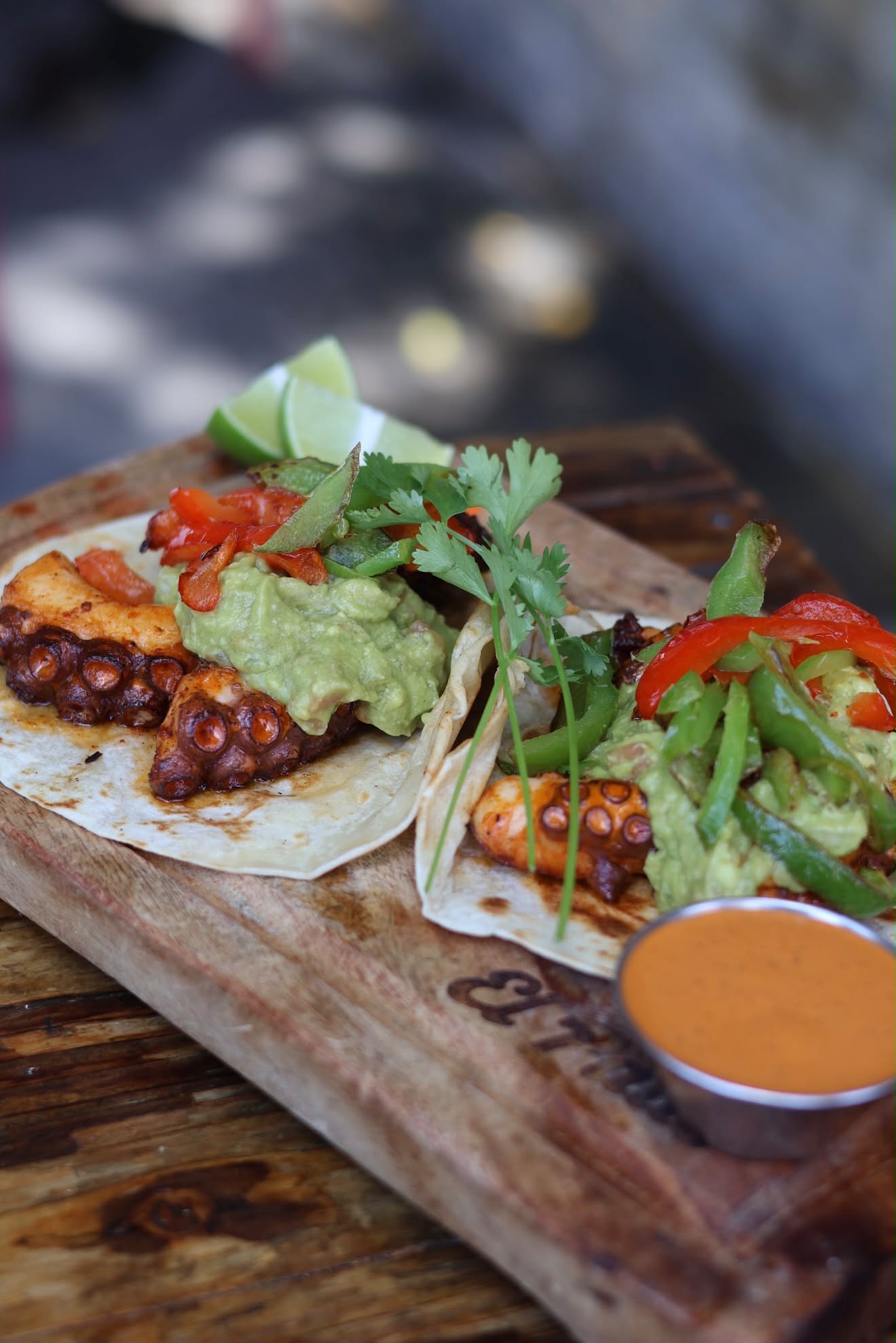 Street tacos served on a wood board at El Patio